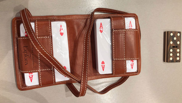 A leather carrying case for playing cards and a crafted hardwood domino were two items showcased in the "Artistry Beyond Boundaries" enrichment talk.