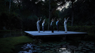 Guests participate in a Full Moon Yoga session at the Four Seasons Bali at Sayan.
