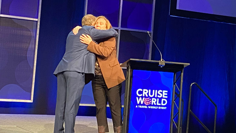 Chad Martin, Israel MInistry of Tourism's director of the U.S. Northeast region, hugged Northstar Travel Group executive vice president Mary Pat Sullivan on the CruiseWorld stage.