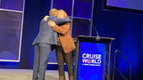 Chad Martin, Israel MInistry of Tourism's director of the U.S. Northeast region, hugged Northstar Travel Group executive vice president Mary Pat Sullivan on the CruiseWorld stage.