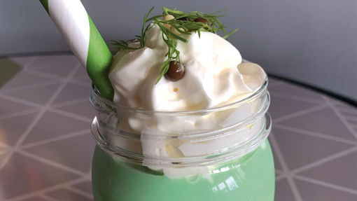 The Pickle Milkshake is complete with a fresh sprig of dill atop the whipped cream. It's served in a plastic souvenir jar and costs $5.75.